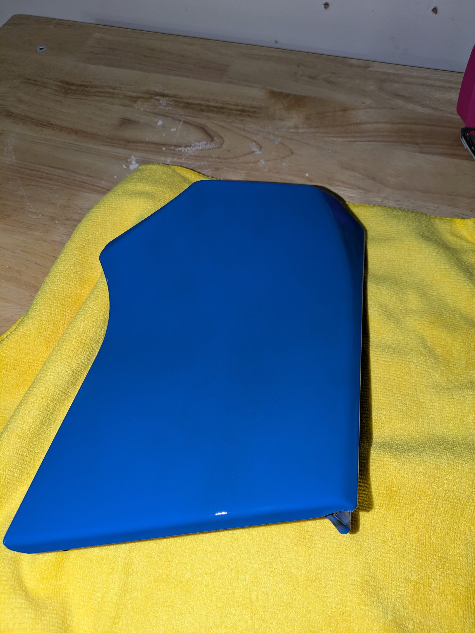 The finished panel, glossy, resting on a microfiber towel on the workbench