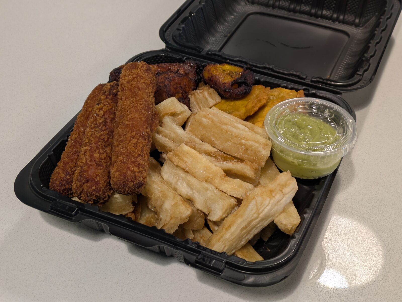 Golden-fried yuca, double-fried tostones, hand-rolled ham croquetas, and sweet caramelized maduros