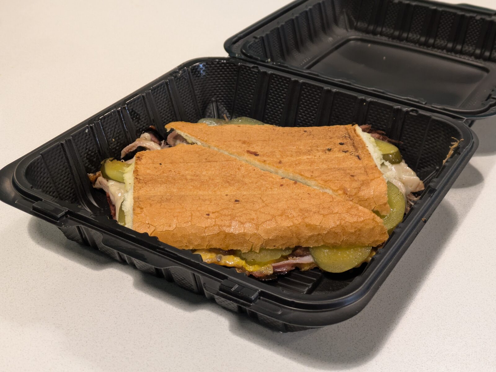 Cuban sandwich in a takeout container