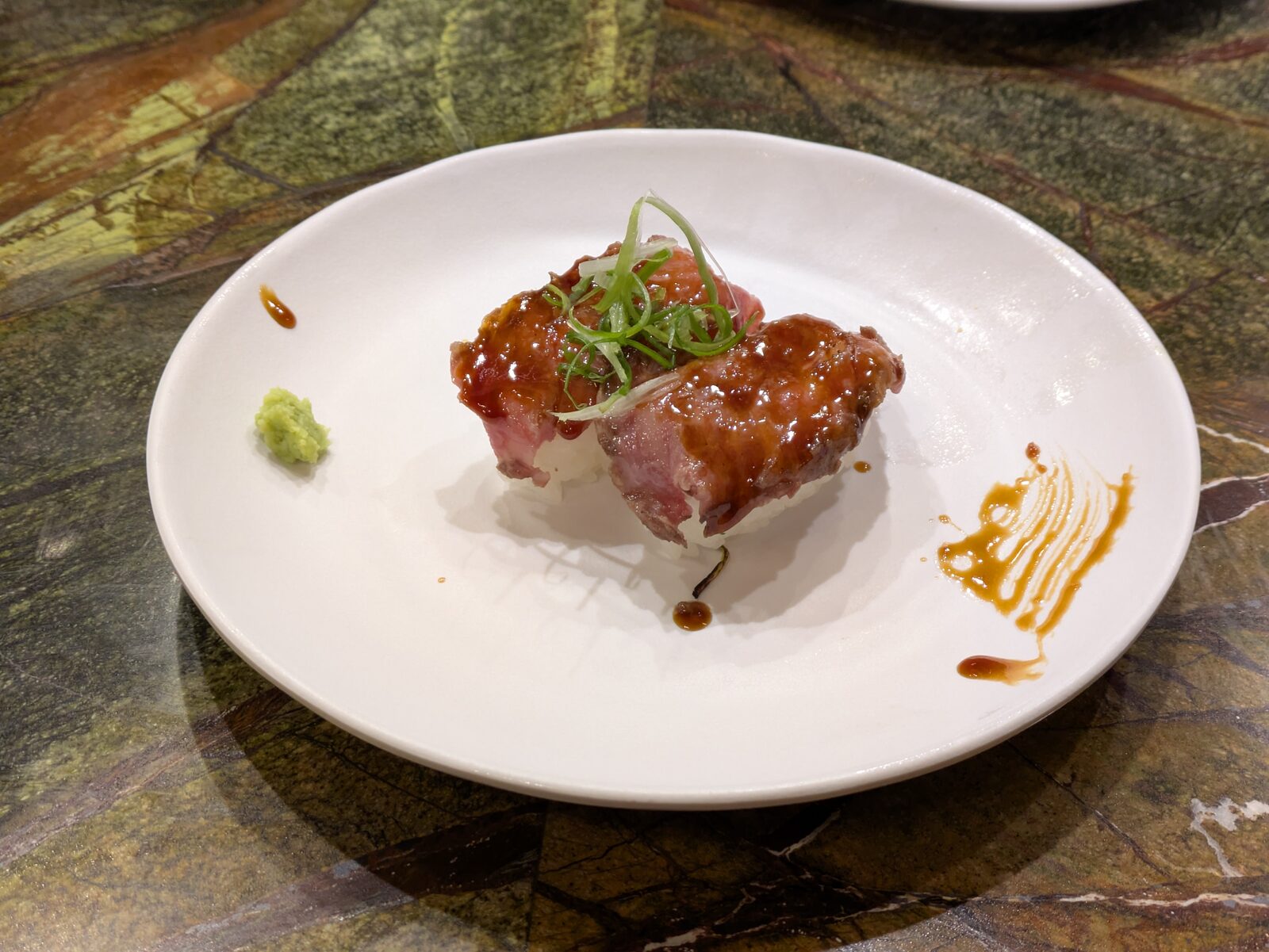 Two pieces of wagyu nigiri on a plate